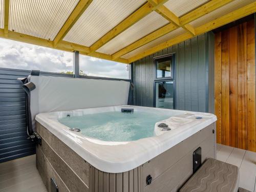 a large bath tub sitting in a room at 1 Bed in Girvan oc-78072 in Girvan