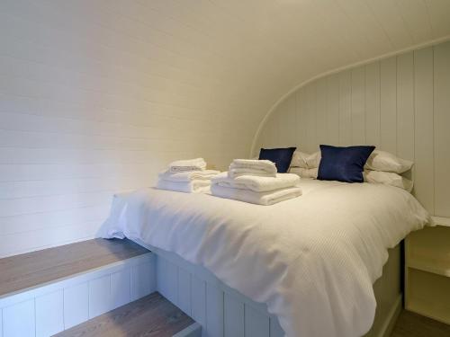 a bed with towels stacked on top of it at 1 Bed in Girvan oc-78073 in Girvan