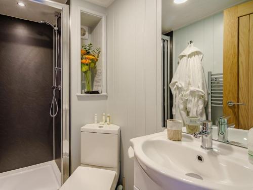 a bathroom with a sink and a toilet and a shower at 1 Bed in Girvan oc-78073 in Girvan