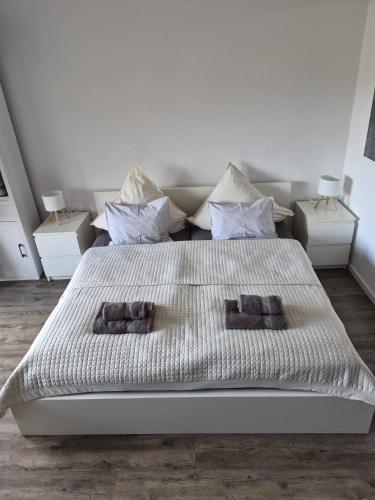 a bedroom with a large bed with two night stands at Gemütliche Auszeit in Bad Rothenfelde in Bad Rothenfelde