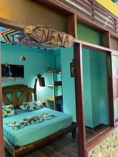 a bedroom with a bunk bed with a surfboard on top at Posada Kauai Experiencia de descanso y conexión en la selva in Mocoa