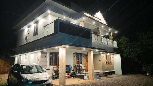 a car parked in front of a house at night at Rambos Inn Homestay in Vagamon