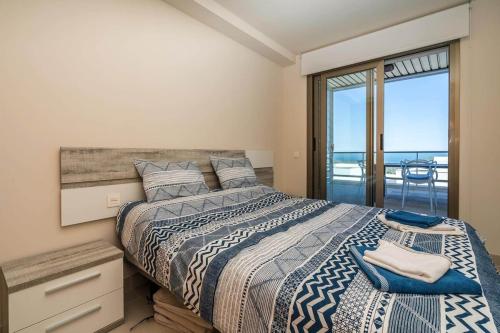 a bedroom with a bed with a view of the ocean at Casa Paulo - Aguilón Golf in San Juan de los Terreros