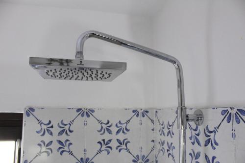 a shower head in a bathroom with a shower curtain at La Scaletta - Charming Historic Center Home - Mountain View in San Nicola Arcella