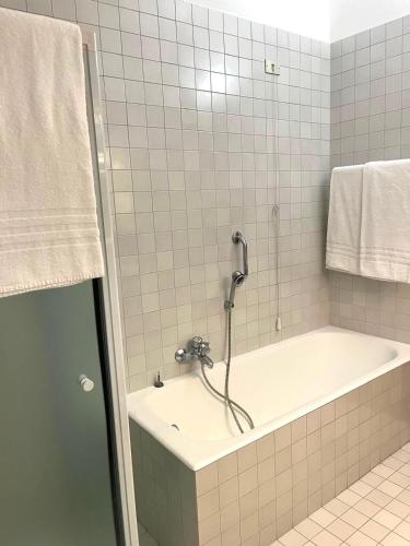a bathroom with a bath tub with a shower at Residenza Arilica - Silkeys in Peschiera del Garda