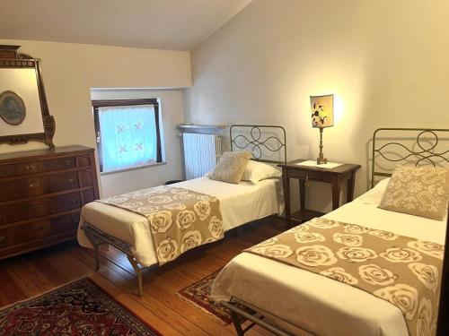 a bedroom with two beds and a window at Residenza Arilica - Silkeys in Peschiera del Garda