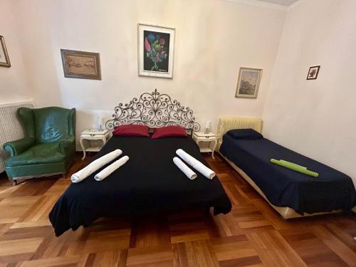 a bedroom with a bed and a green chair at Suite in Private Villa in Milan