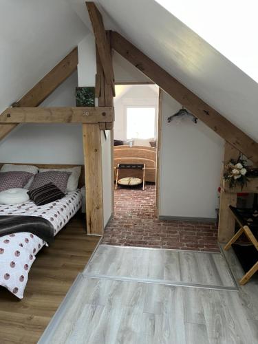 a bedroom with a bunk bed in a attic at Le CappyToiT - Gîte climatisé in Cappy