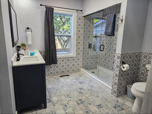 a bathroom with a sink and a shower at Casa Azul- Entire Lakefront Cottage with Hot Tub in Leamington