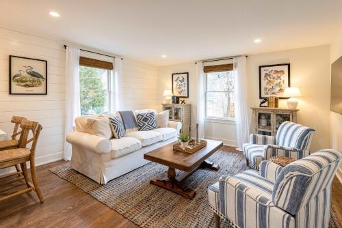 a living room with two couches and a table at Kildahl House - Boutique Farmhouse Suite #3 in West Dundee