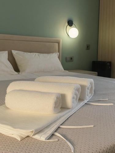 two white towels on a bed in a room at SAFIA Hotel in Pavlodar