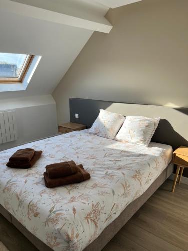 a bedroom with a bed with two towels on it at L'Arsenal Loft in Couvin