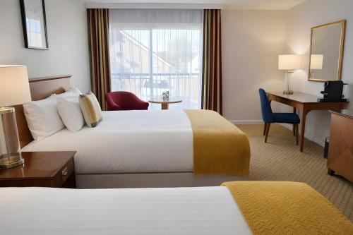a hotel room with two beds and a window at The Aberdeen Dyce Hotel in Dyce