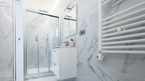 a white bathroom with a shower and a toilet at BORGO MARE 86 rooms in Porto SantʼElpidio