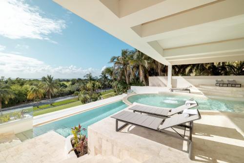 an image of a swimming pool with a patio furniture next to a villa at Secrets Mirabel Cancún Resort & Spa - Adults Only - New Spa now open! in Cancún