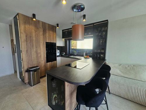 a kitchen with a large black island in a room at Rakoczówka in Znamirowice
