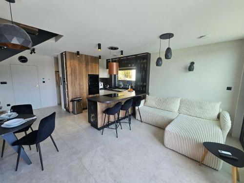 a living room with a couch and a table and chairs at Rakoczówka in Znamirowice