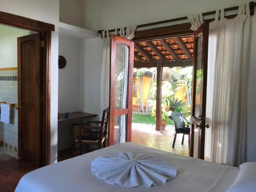 a bedroom with a bed and a door to a patio at Habitacion Mar in Puerto Escondido