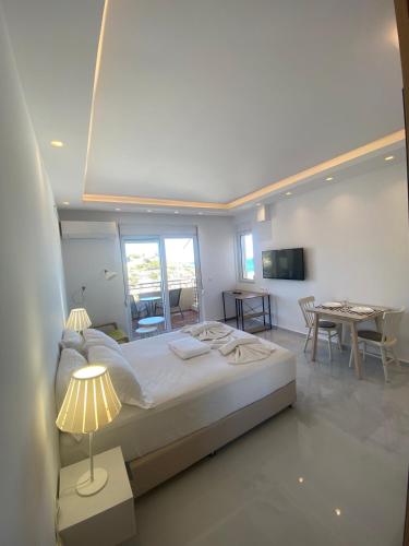 a bedroom with a large bed and a dining room at Panoramic View Boutique Suite in Rethymno