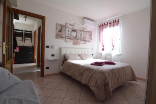 a bedroom with a bed and a window at Casa Verena in Aosta