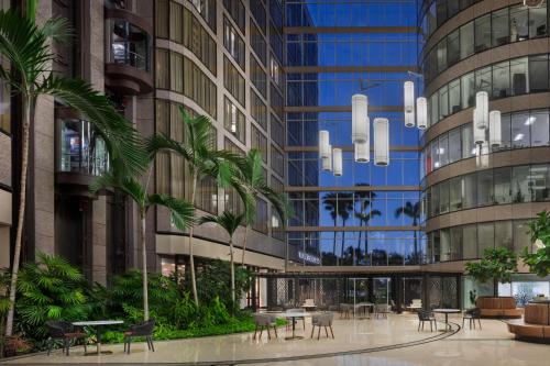 a rendering of a building with tables and chairs at The Westshore Grand, Tampa, A Tribute Portfolio Hotel in Tampa