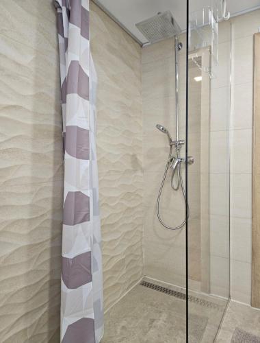 a shower with a glass door in a bathroom at Sea Paradise Piran in Piran