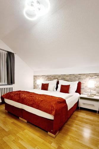 a bedroom with a large bed with a red blanket at Apartment Loindl in Unterach am Attersee