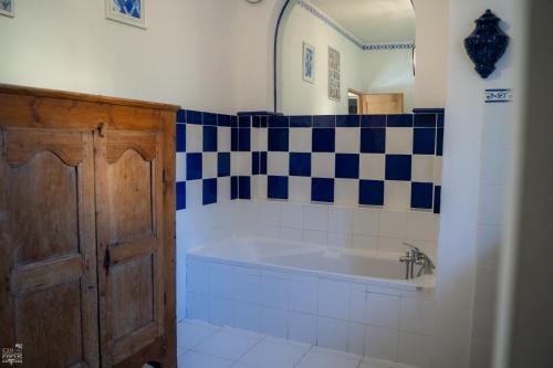 a bathroom with a bath tub in a room at Bastide de Valvérane in Manosque