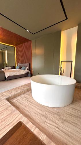 a large white tub in a room with two beds at مجموعة سدرة فاطمة in Al Ahsa