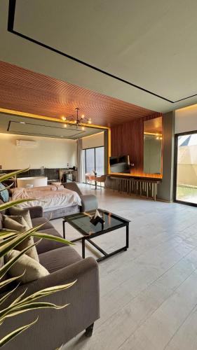 a bedroom with a bed and a couch and a table at مجموعة سدرة فاطمة in Al Ahsa