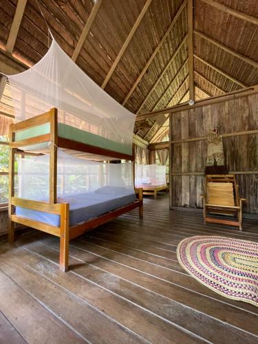 a bedroom with a bunk bed in a tent at CHUNAKI ECOLODGES - Authentic Activities and Food in the Amazon in Zaragoza