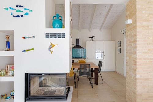 a living room and dining room with a fireplace at Villa dei Gruccioni - YourPlace Abruzzo in Torino di Sangro