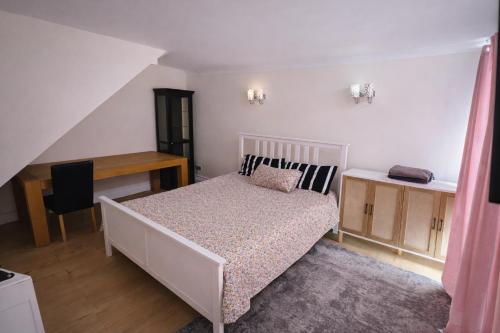 a bedroom with a bed and a desk and a table at ValueStays Chalvey Free Parking in Slough