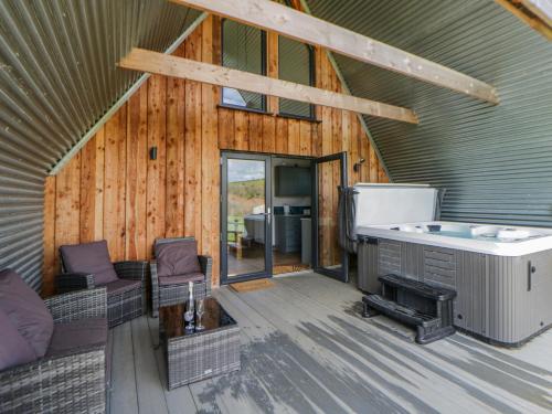 a living room with a hot tub in a house at Valley View Hideaway in Llandysul