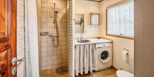 a bathroom with a shower and a washing machine at VE361-Vejers-Strand-Violvej-4 in Vejers Strand