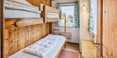 a bedroom with two bunk beds and a window at VE361-Vejers-Strand-Violvej-4 in Vejers Strand