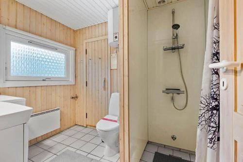 a bathroom with a toilet and a shower at VE494-Orbaek-Jafdalvej-51 in Ørbæk