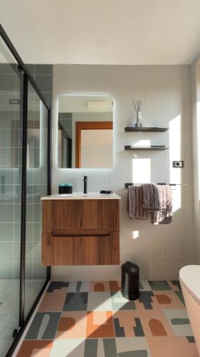a bathroom with a sink and a mirror at Casa Alba Blu in Dogliani