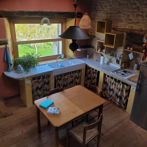 a kitchen with a wooden table and a sink and a table and a tablektop at Casa della Casa in San Severino Marche