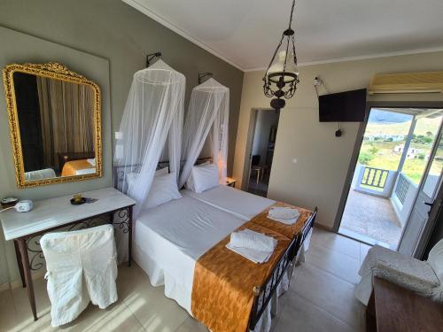 a bedroom with a canopy bed with a mirror at Villa Niki in Serifos Chora