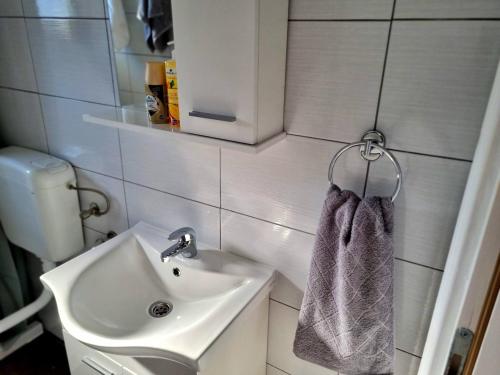 a bathroom with a sink and a towel at Holiday Home with Private Pool in Blagaj