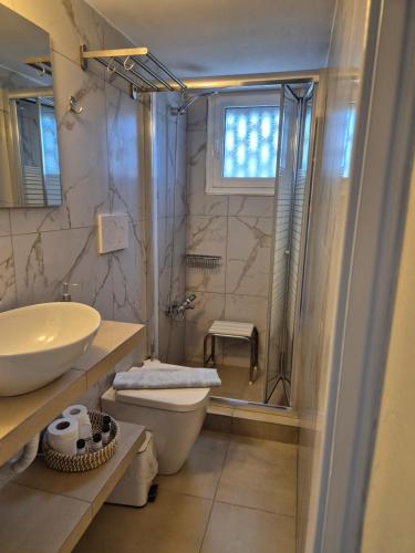 a bathroom with a sink and a toilet and a shower at Villa Niki in Serifos Chora