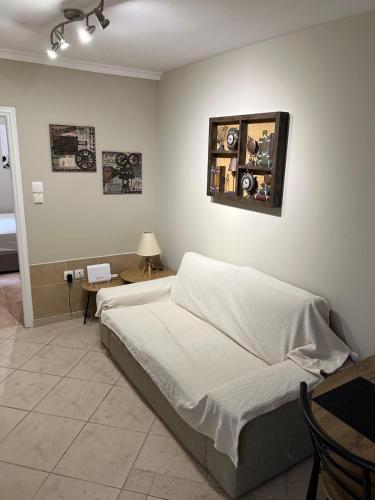 a bedroom with two beds and a table with a lamp at Nice apartment close to the sea in Athens
