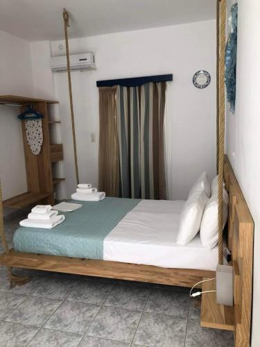 a bedroom with a swing bed with towels on it at Atlantis Place Milos in Adamantas