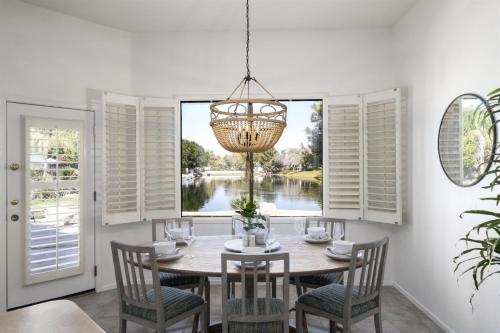 a dining room with a table and chairs and a window at Gorgeous Lakefront Paradise w Pool & Views in Chandler