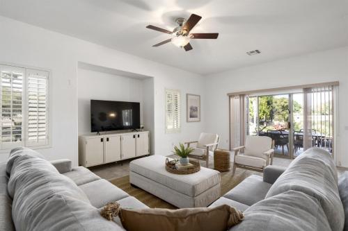 a living room with a couch and a ceiling fan at Gorgeous Lakefront Paradise w Pool & Views in Chandler