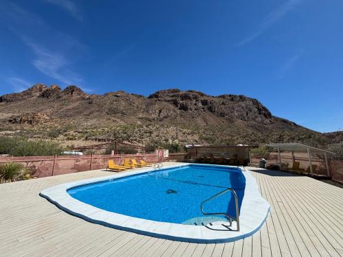 a swimming pool with a mountain in the background at Terlingua Ranch Lodge in Terlingua