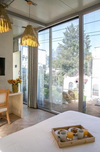 a bedroom with a bed with a tray of food on it at Casa JuliAna in Mexico City