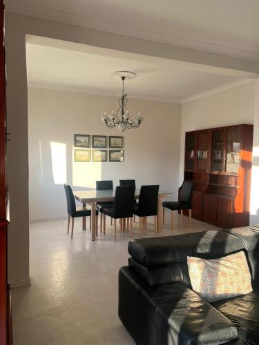 a living room with a dining room table and chairs at Spacious & Central 3-Bedroom Apartment Close to the Sea in Taʼ Xbiex