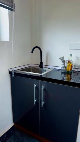 a kitchen with a sink and a counter top at Mayama Residences in Accra